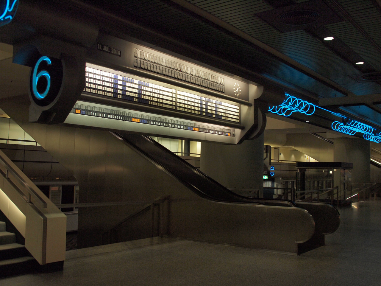 An information board and blue neon lights inside the ICC Berlin.