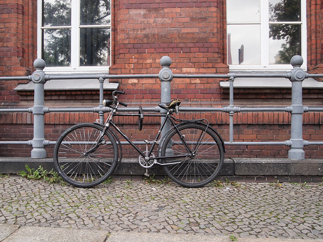 A vintage bicycle with a big bike lock.